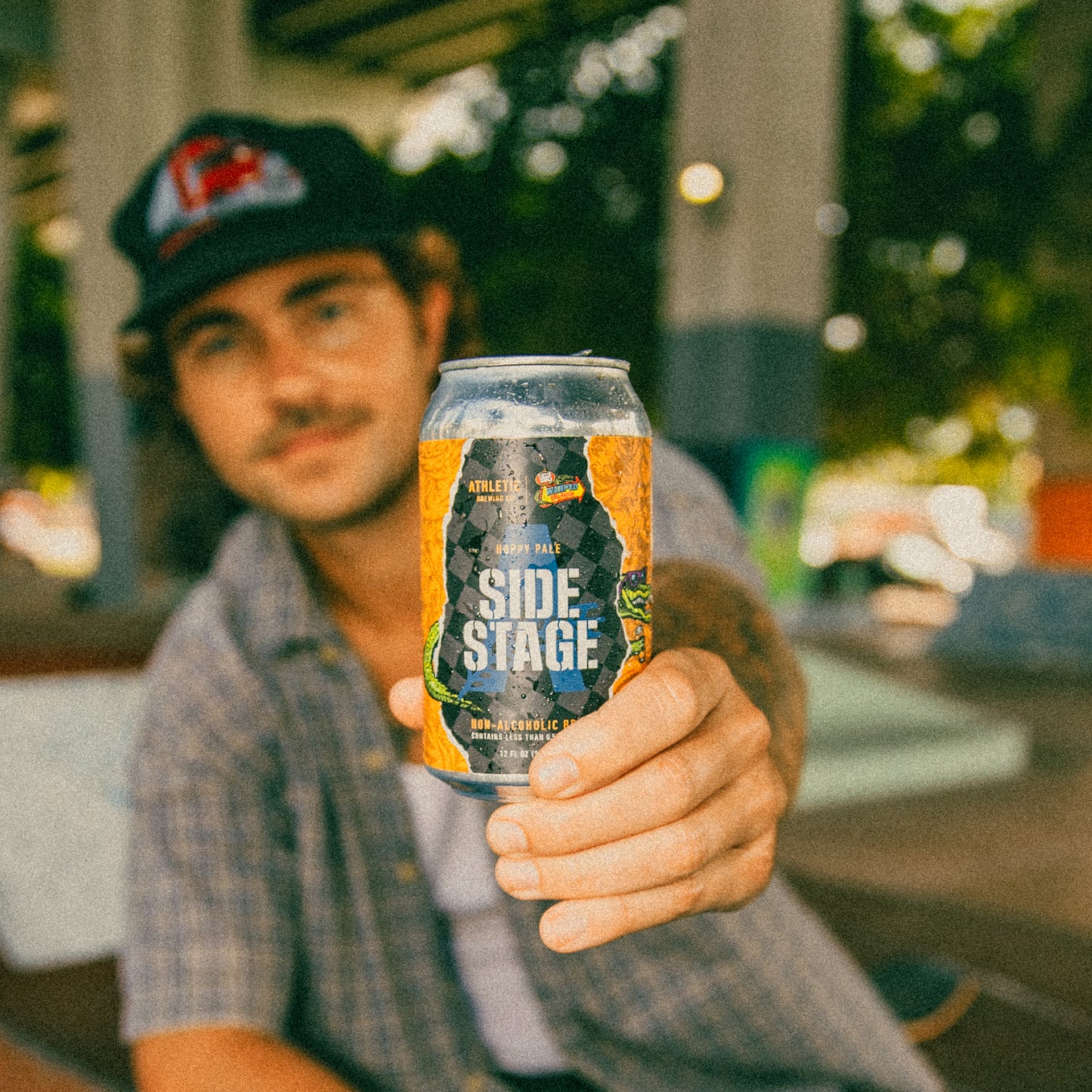 a skater holding a side stage beer can
